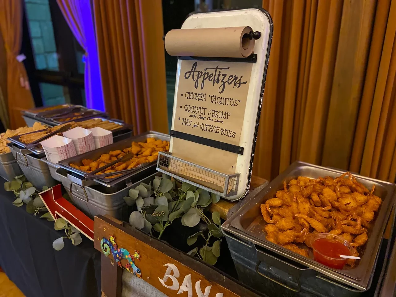 Appetizer station with menu sign and food trays